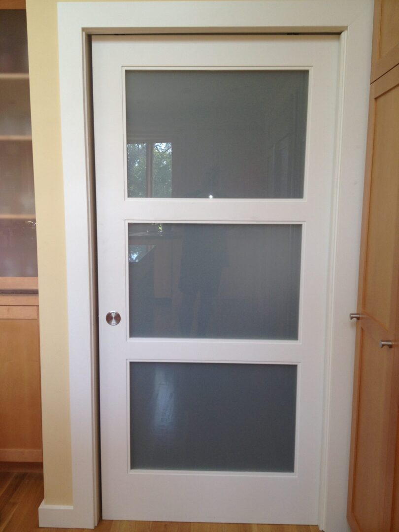 A door with three glass panels in it.