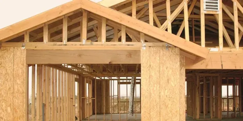 A building under construction with wood framing.