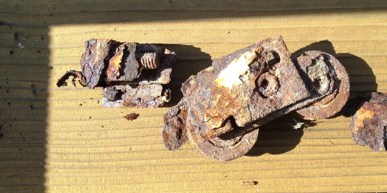 A piece of metal that is broken and rusty.