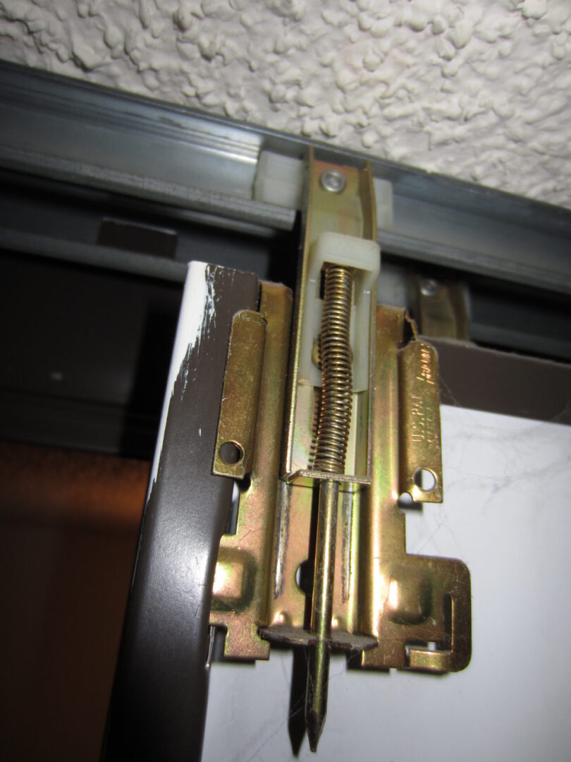 A door hinge with some bolts and nuts