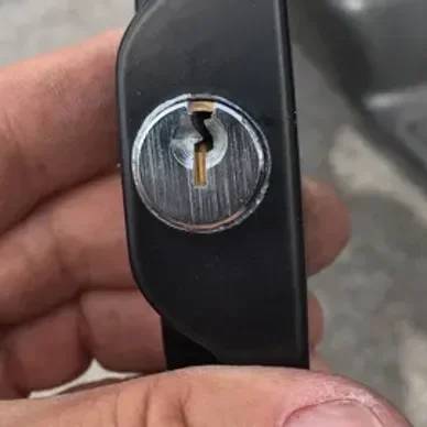 A person holding a key to their car.